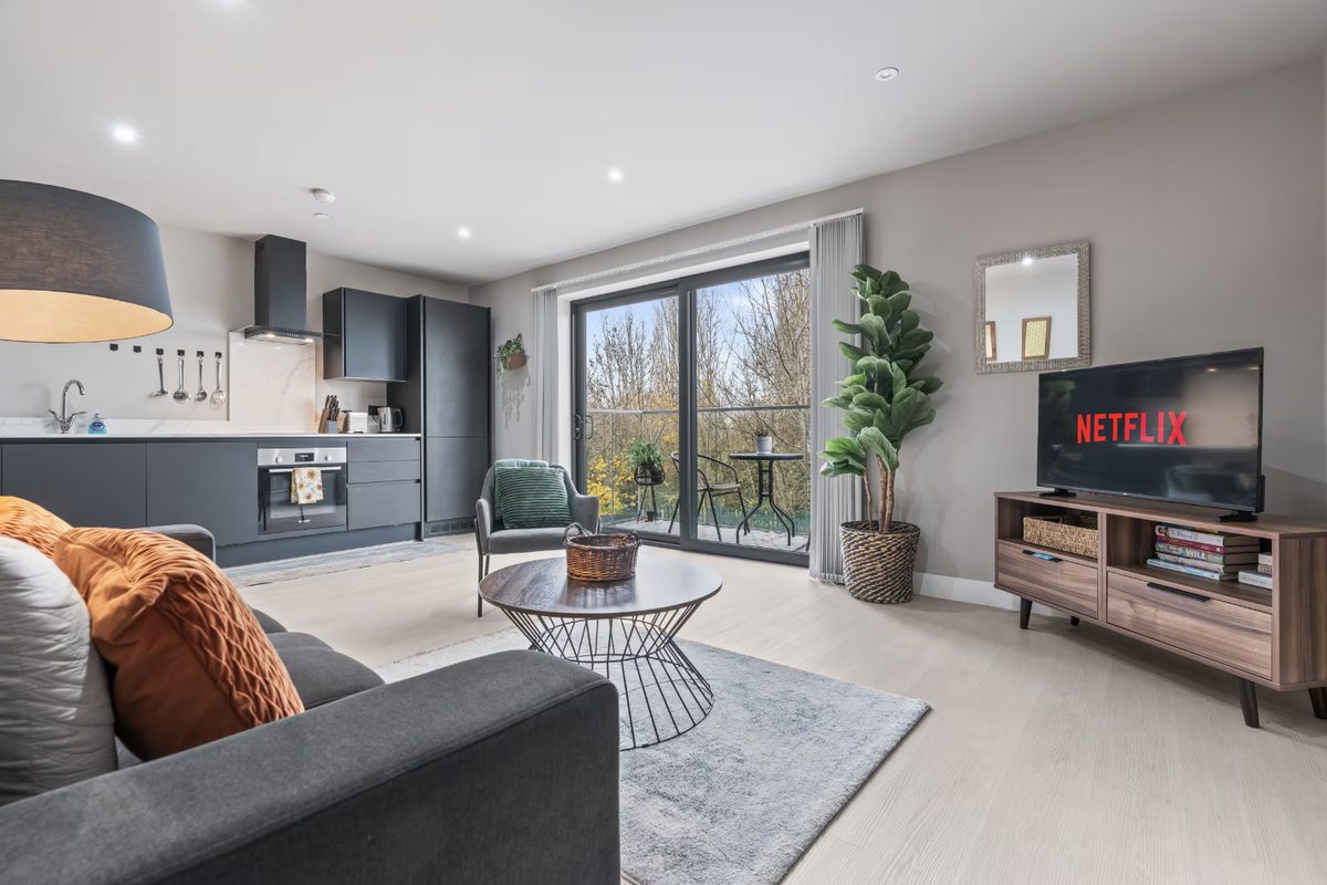 Open-plan living room and kitchen with dark grey cabinets